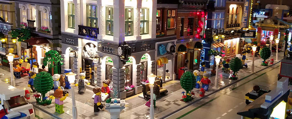 Small portion of LEGO downtown buildings lit up with LED lights